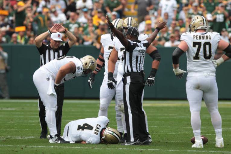 Derek Carr of the Saints is being examined for a shoulder injury following the Packers' defeat